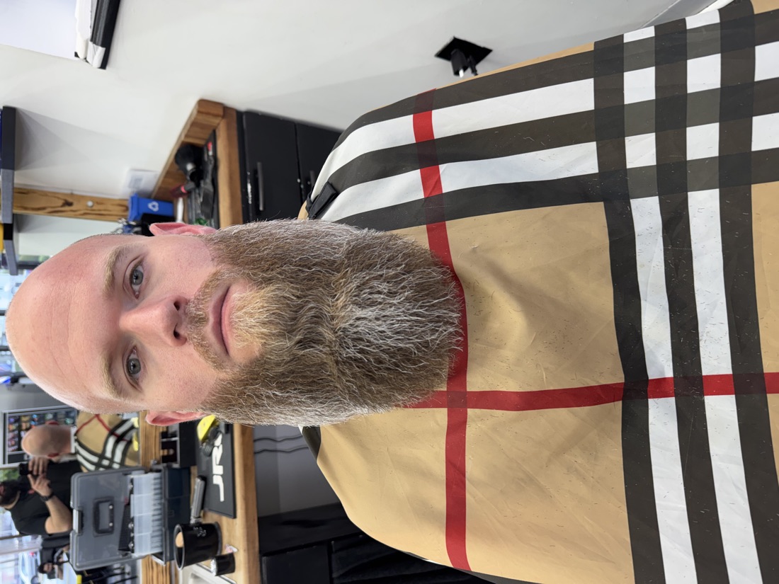 Client with a long full beard in the chair before shaping at Slick Fades