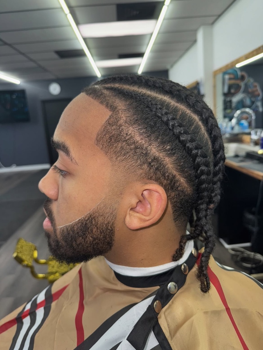 Braids with a taper fade and beard lineup from Slick Fades