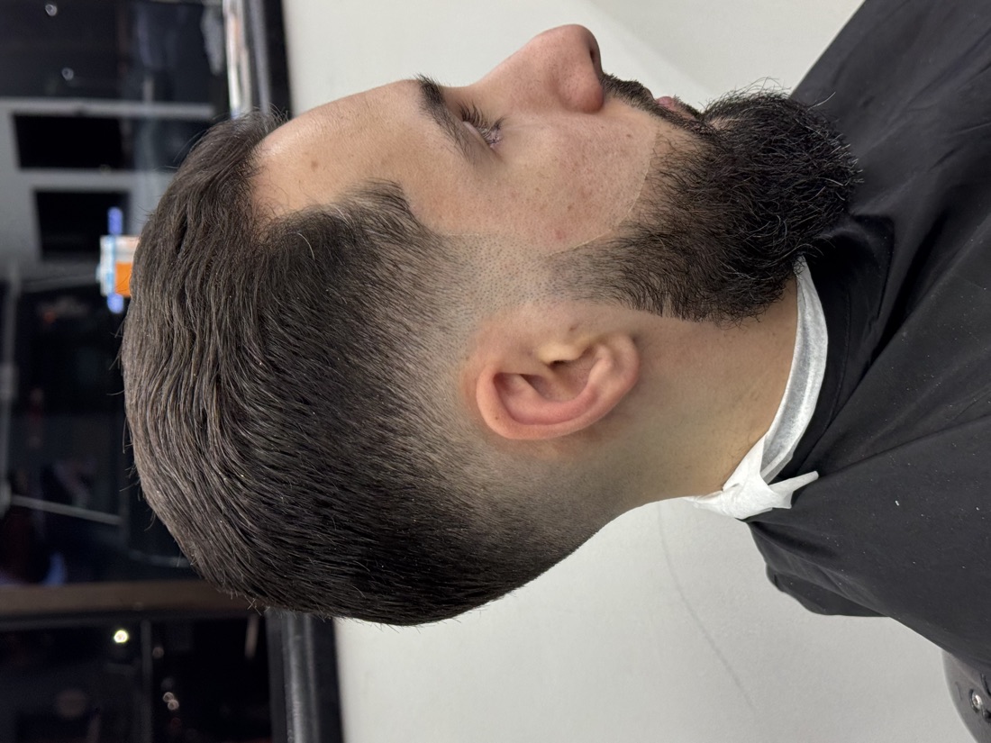 Low fade blended into a full sculpted beard at Slick Fades North Olmsted