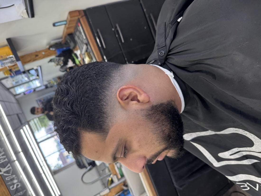 Low skin fade blended into a full beard at Slick Fades North Olmsted