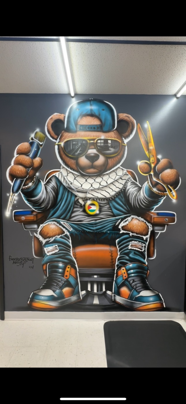 The Slick Fades bear mural painted floor to ceiling on the shop wall in North Olmsted