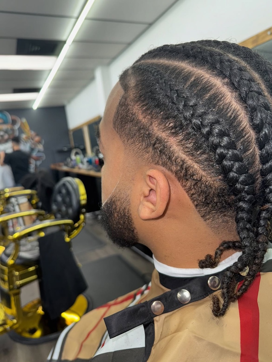 Barber putting finishing touches on a taper fade and beard at Slick Fades Barber Shop